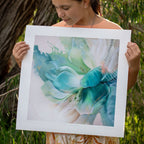 Person holding a fine art abstract floral print by Eva Cassini outdoors