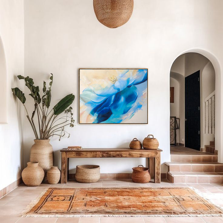 Foyer with a wooden console table, original abstract painting, and decorative vases.