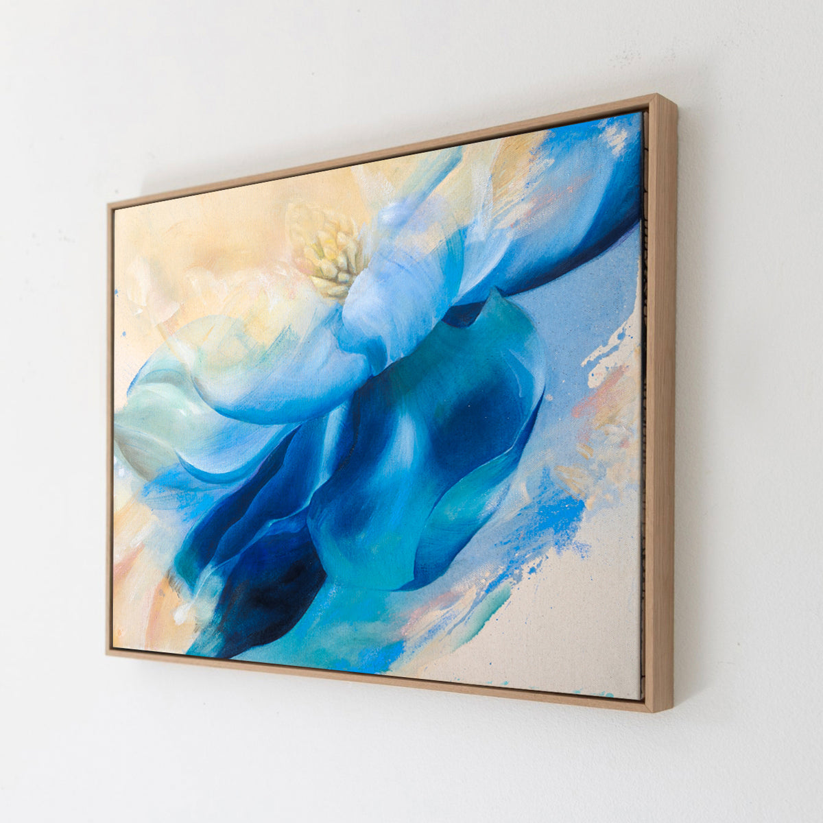 Abstract painting, State of Flow by Eva Cassini, with blue and beige colors in a wooden frame on a white wall