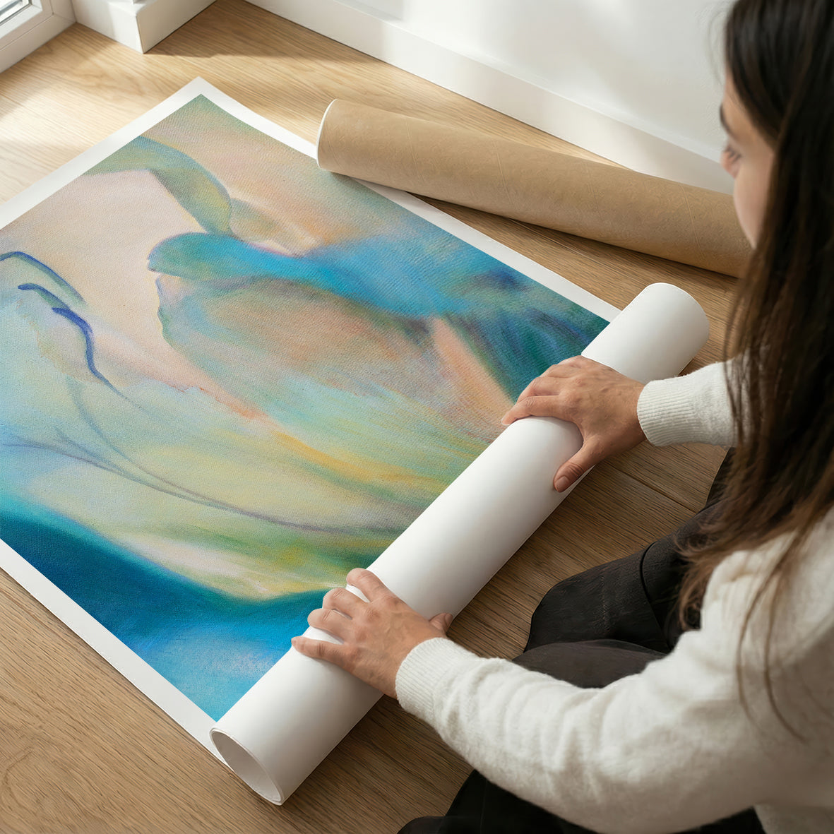 Person unrolling a large colorful abstract floral fine art print
