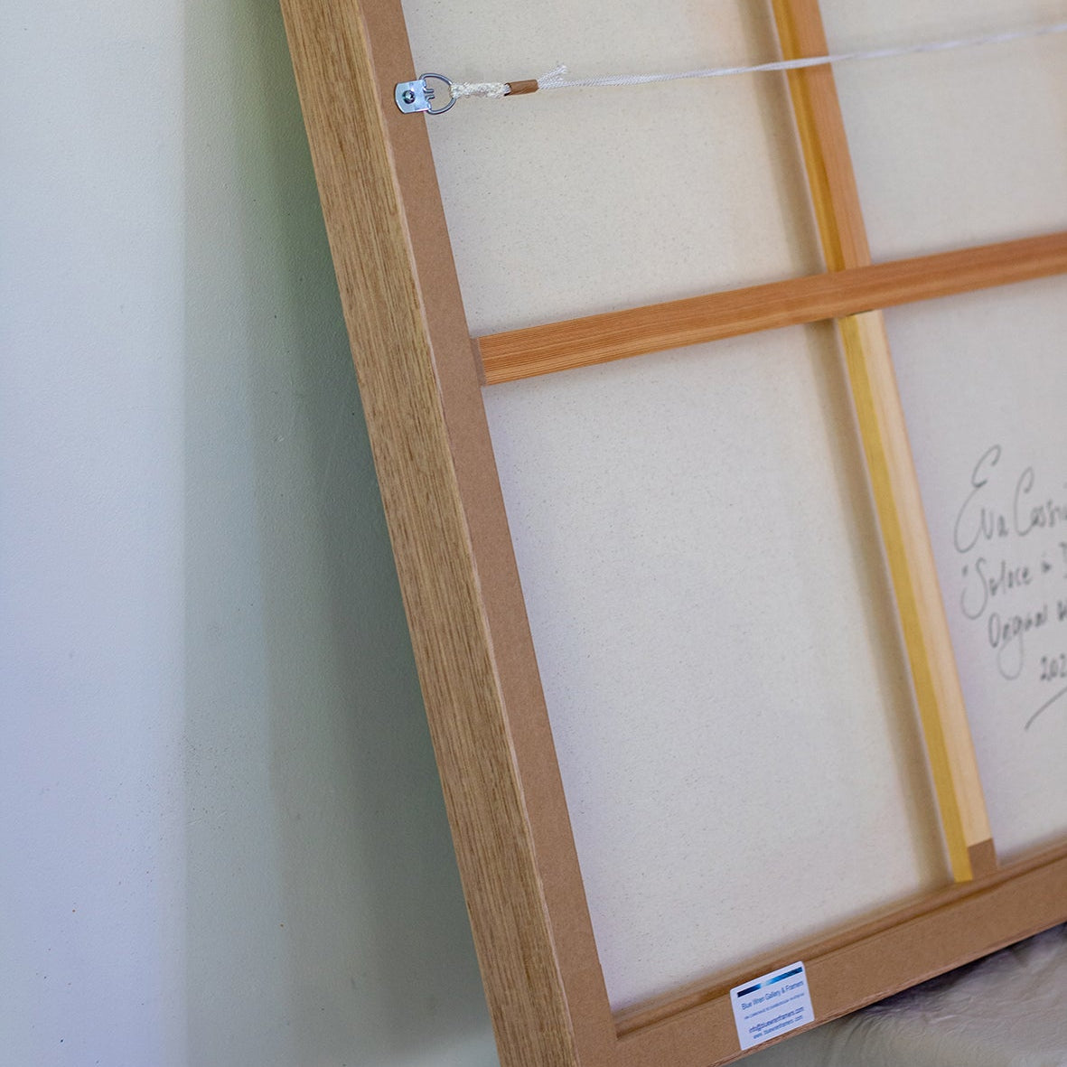 Detail of reverse of frame and original painting, showing hardware and professional construction