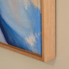 Close-up of a painting with a wooden frame on a beige wall