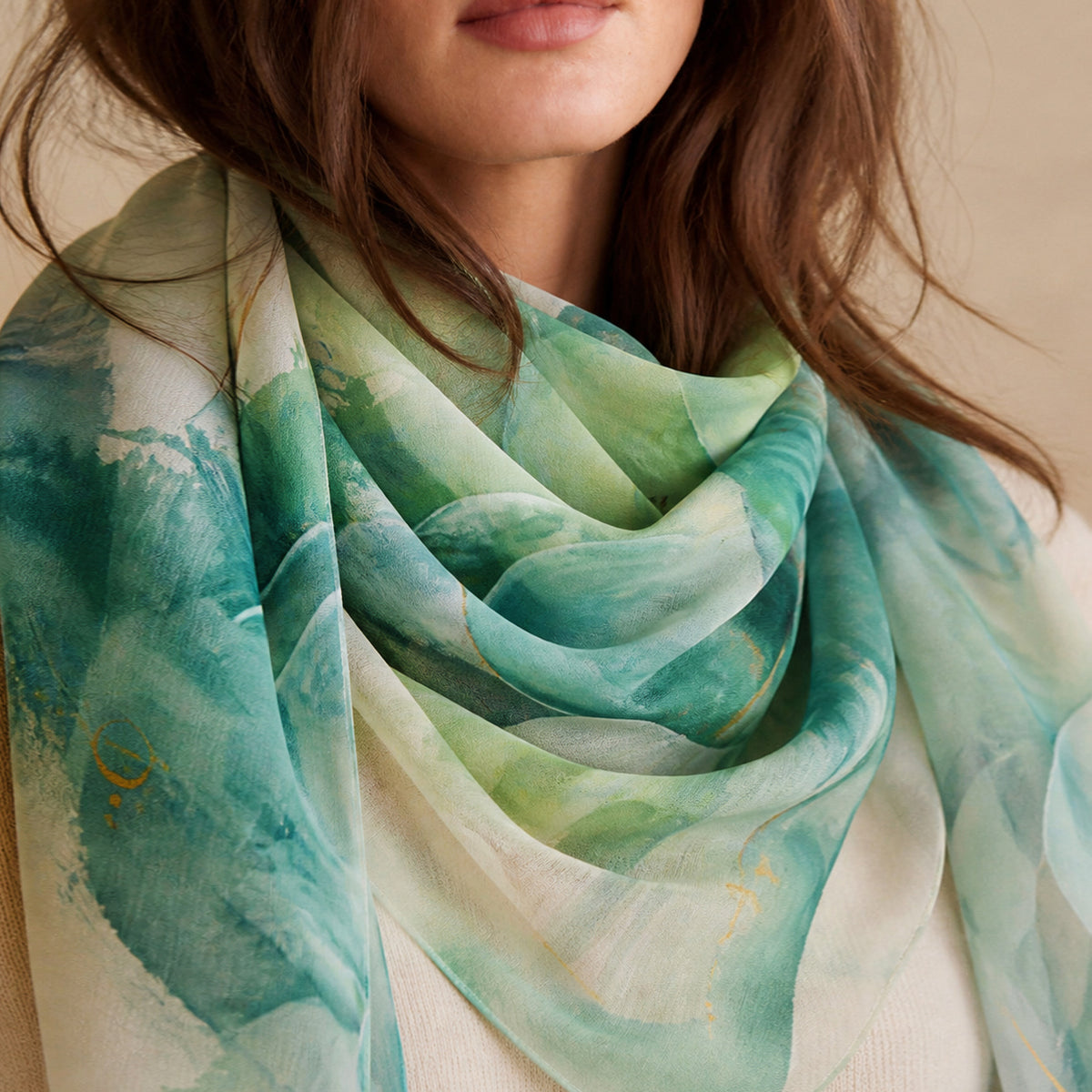 Person wearing a scarf in oceanic aqua and jade from the original painting, The Endless Great Unfolding